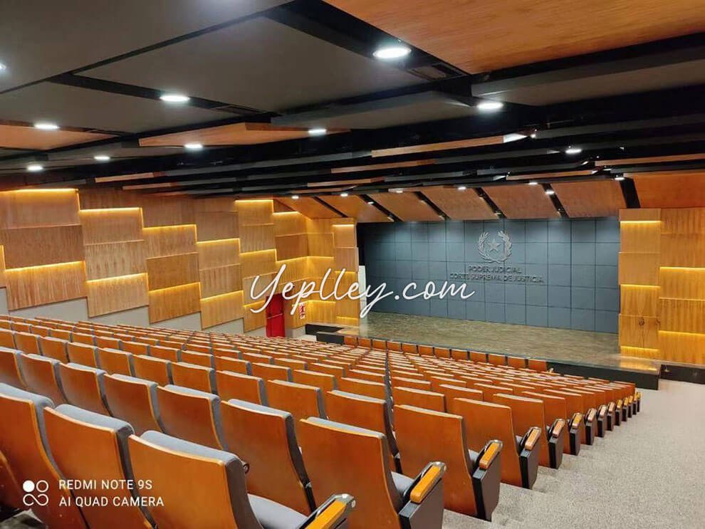 Close-up of the cost-effective chair auditorium model showing the iron legs and plywood outer shell with a paint finish.
