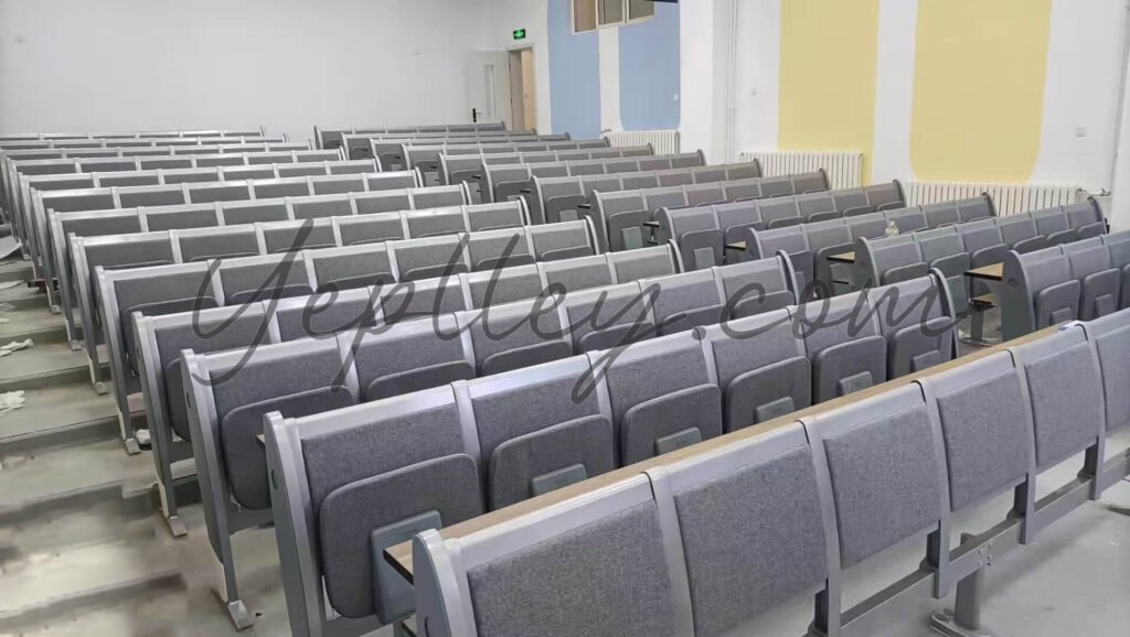Full view of a renovated lecture hall featuring 234 customized student desks and chairs with aluminum legs and fixed writing tablets