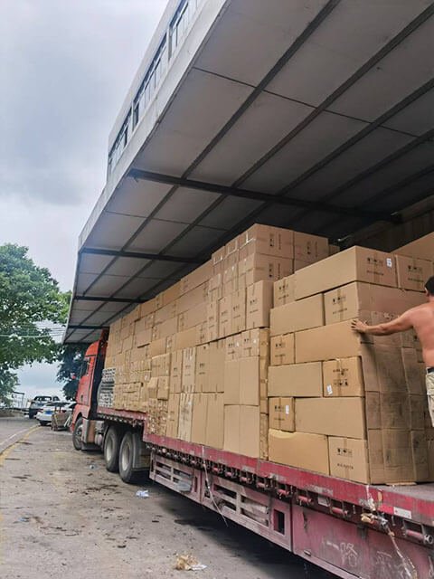 Workers loading school furniture into trucks at Yeplley warehouse
