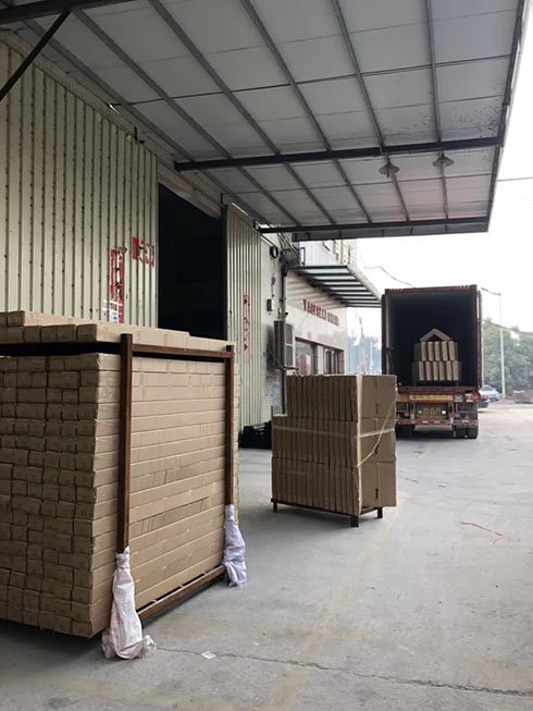 Forklift arranging packed auditorium seating for container loading