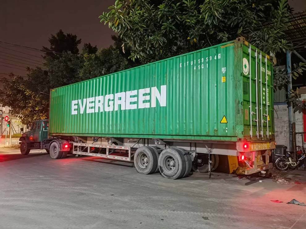 Night-time container loading of airport bench shipment in China factory