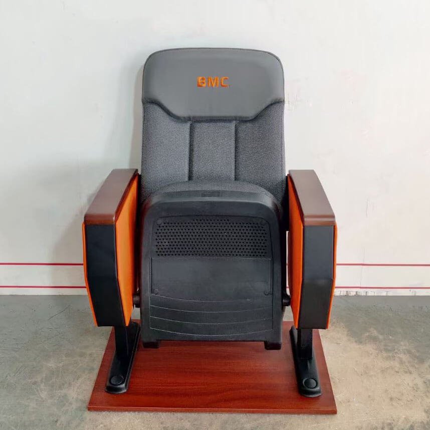 Close-up of auditorium seating logo embroidery quality, showing precise stitching and thread detail on the chair fabric.