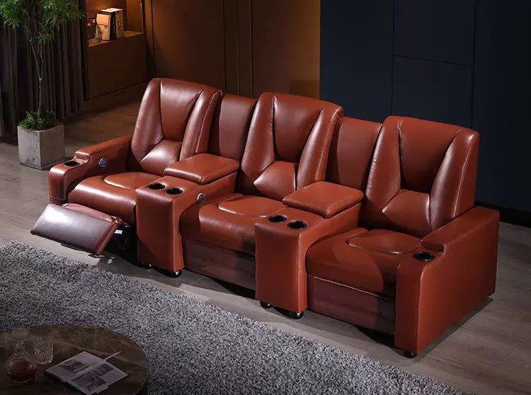 Luxury commercial theater seating in a 3-seat row with recliner function and built-in cup holders