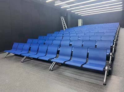 Durable armless waiting room chairs in a mid-sized company meeting hall