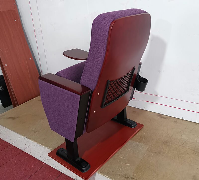 The image shows additional accessories such as cup holders or book nets behind the auditorium seats.
